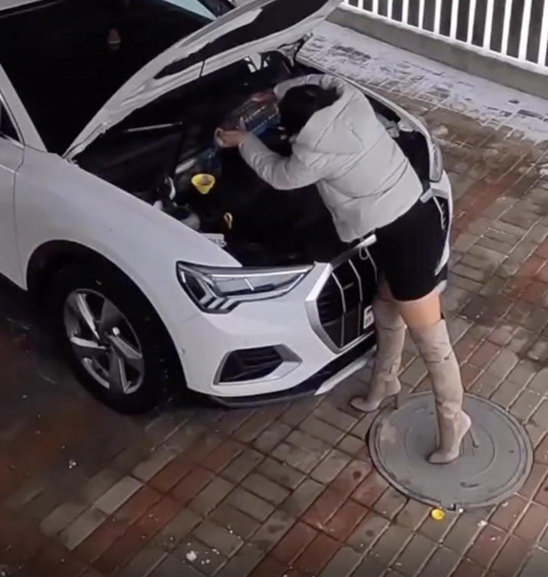 Woman puts cooking oil in the motor oil tank. 