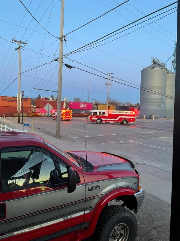 “Ambulance and fire truck waiting for train”