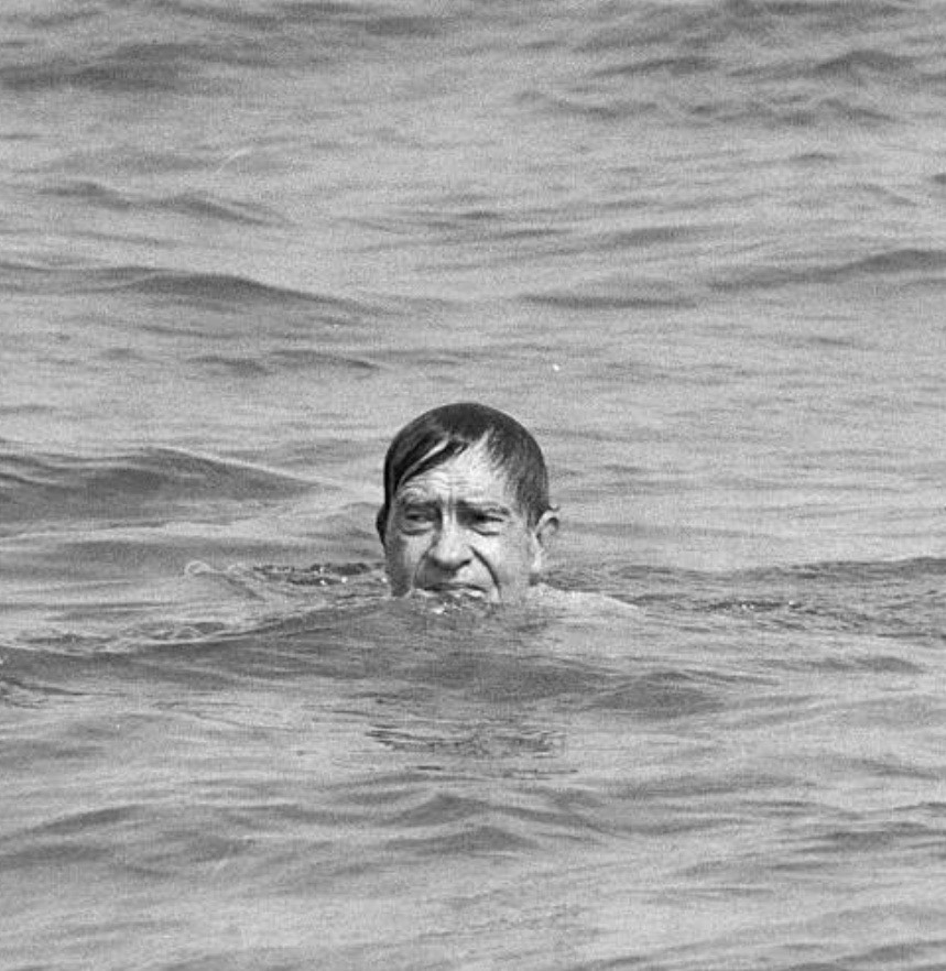 Richard Nixon having a swim in the ocean.