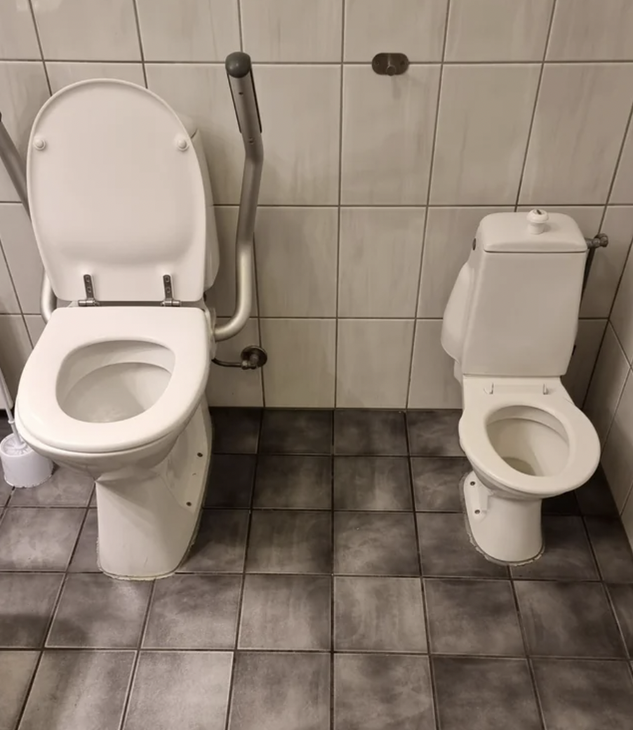 This public bathroom in Norway has one toilet for the parent and a smaller one for their child.