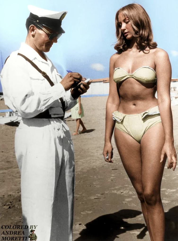 A traffic cop fines a woman for wearing a bikini. Rimini, Italy, 1957.