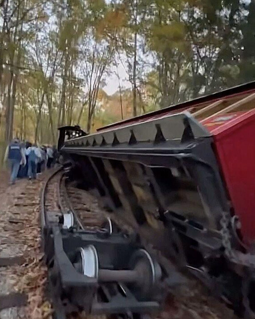 An amusement park train derailed and flipped over.