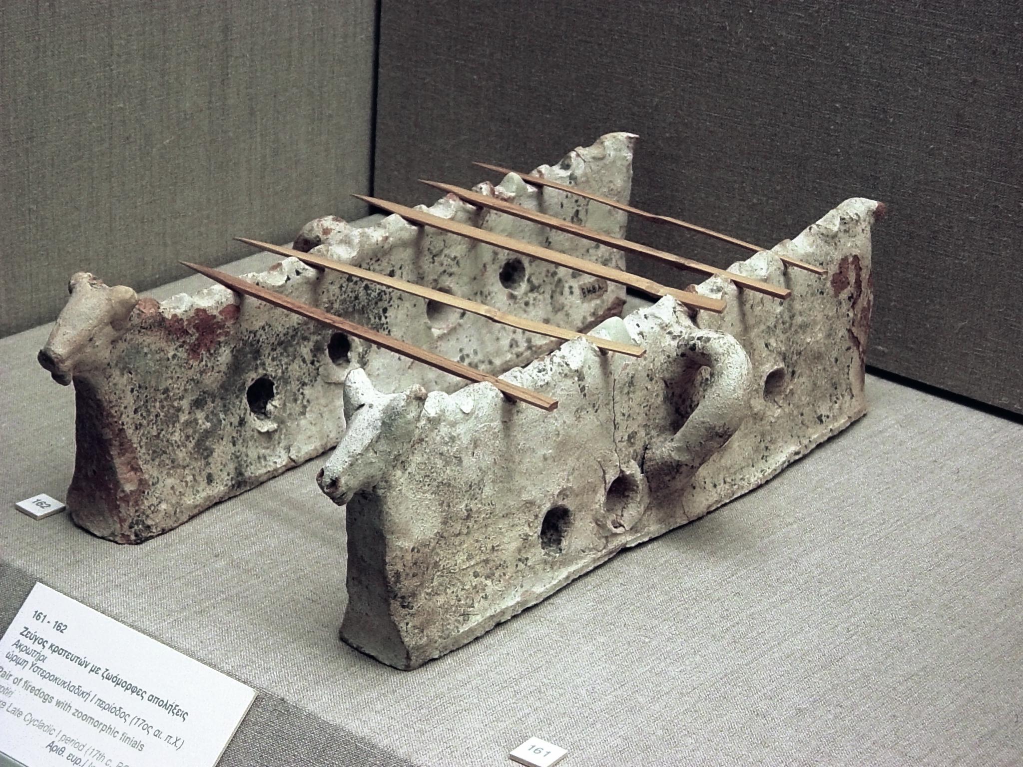 Stone cooking supports used to grill skewers of meat by Minoans on Santorini, circa 1600 BCE. The line of holes in the base supplied coals with oxygen. Many consider modern "souvlaki" street kebabs a direct descendant of this portable food system. Museum of Prehistoric Thera, Greece.