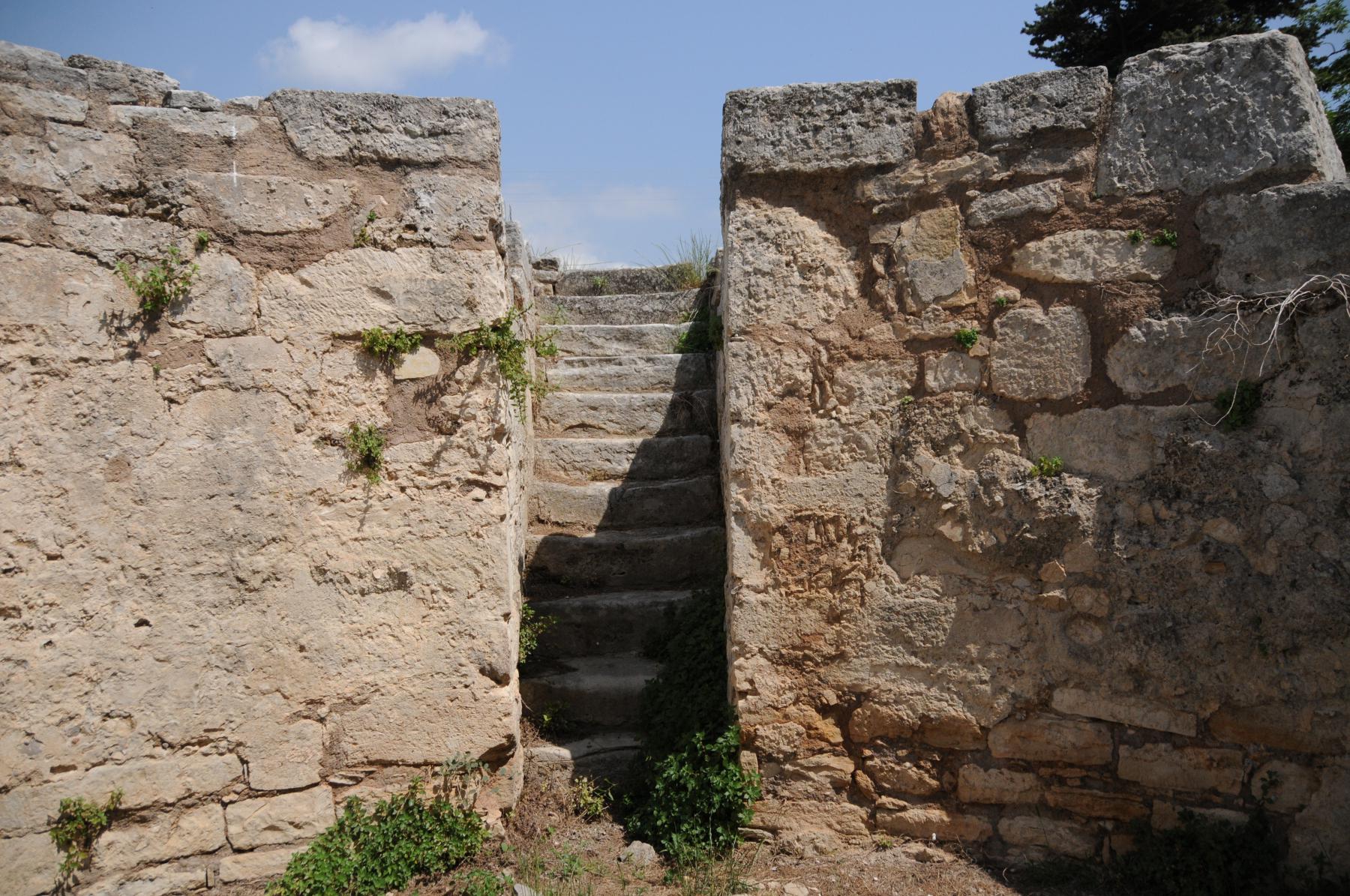 Stairs leading to a Minoan cistern used for the collection of spring water, circa 1330-1200 BCE. An aqueduct moved the supply across three kilometers, with charcoal-filled tubes for activated carbon filtration. The walls were plastered, holding roughly 100 cubic meters of liquid. Tylissos, Crete.