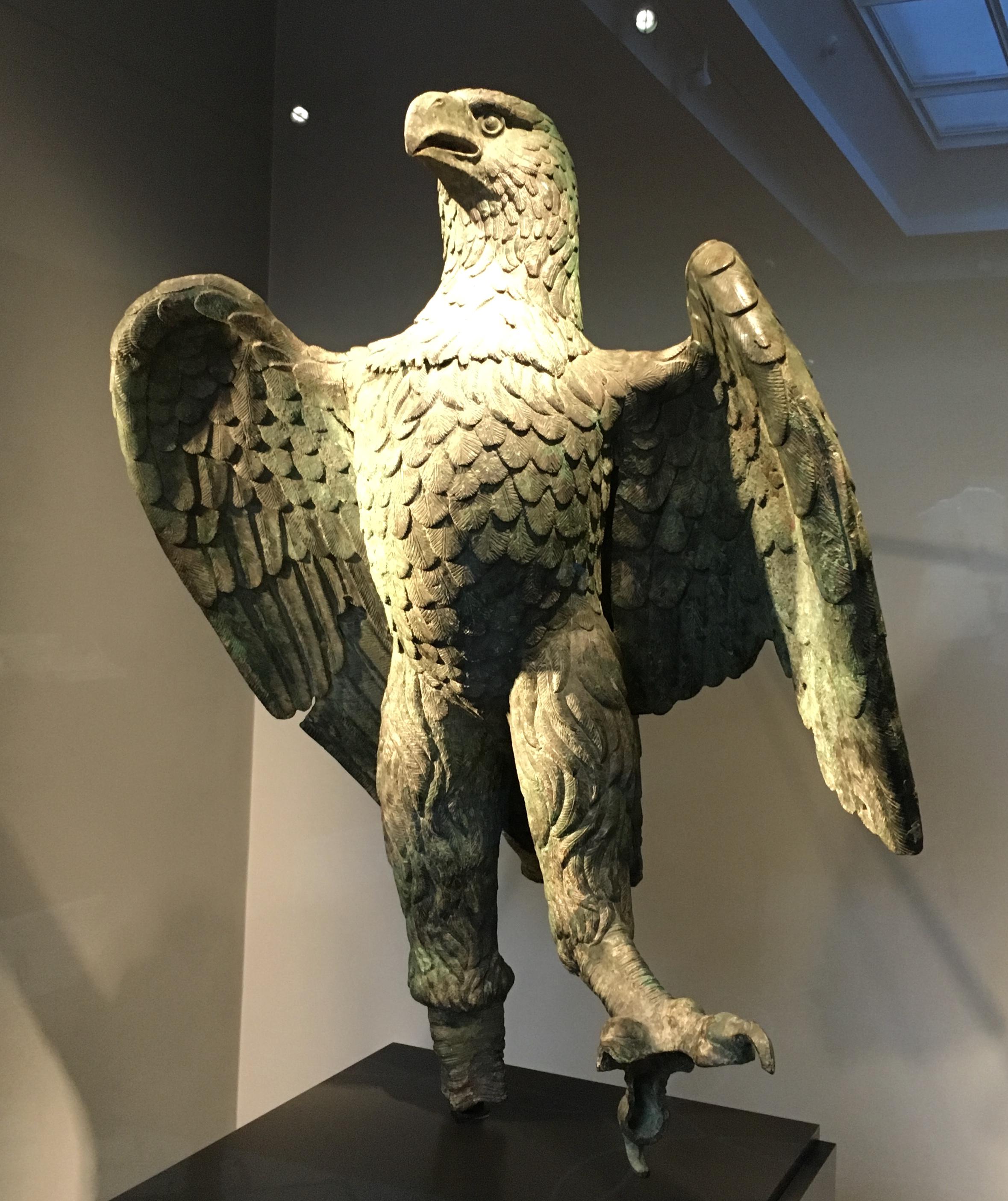 Bronze Roman eagle, crafted 100-200 CE, which complemented a sculptural ensemble representative of either Jupiter or an emperor. It probably grasped a globe or thunderbolt in its raised talon. Getty Villa. Pacific Palisades, CA. 