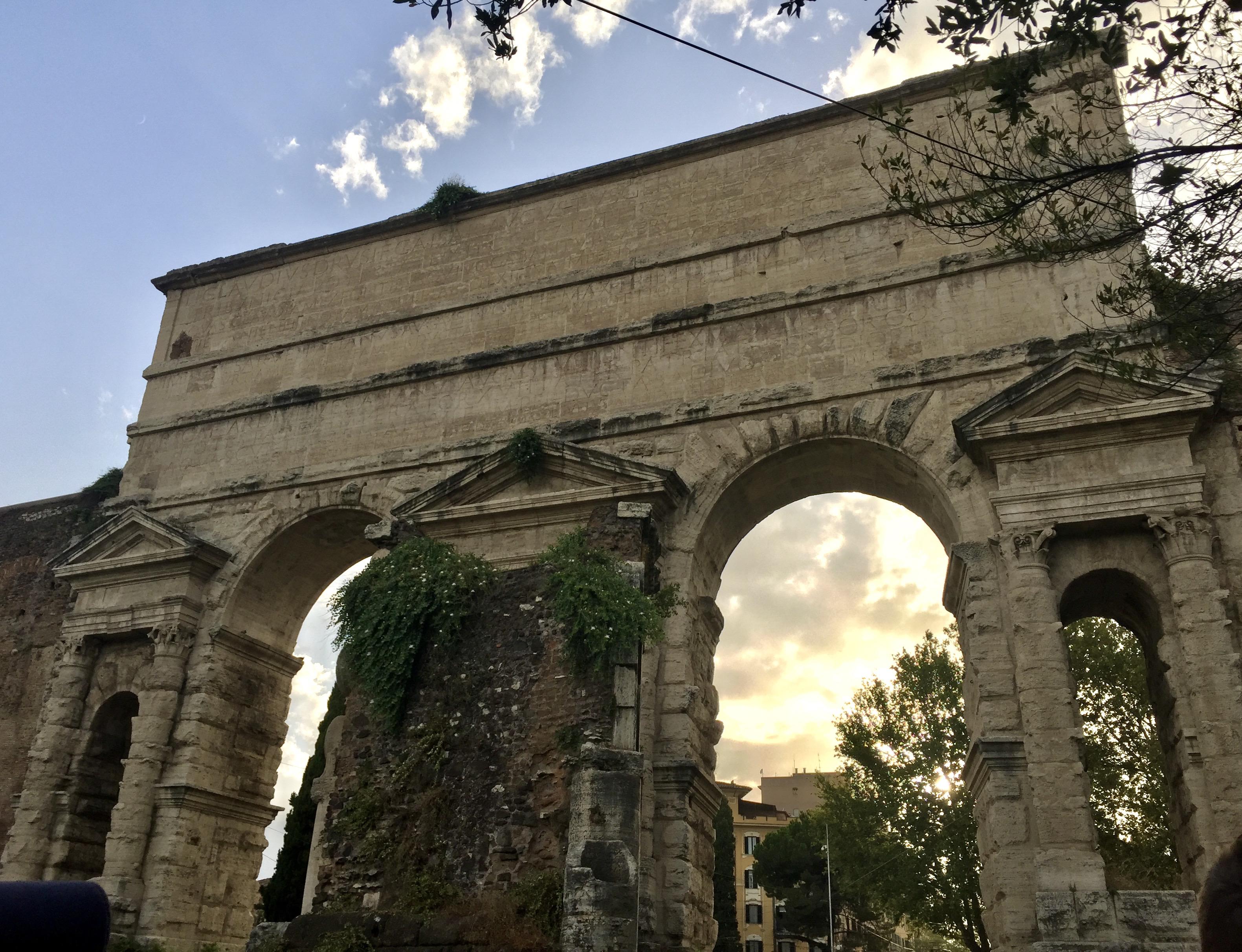 The Emperor Claudius built the Porta Maggiore, a monumental double-arch connecting two Roman aqueducts, on the border of the Esquiline Hill in 52 CE. By 275 CE, the structure was incorporated into the Aurelian Walls, transforming this travertine decoration into a pivotal defense. Rome, Italy. 