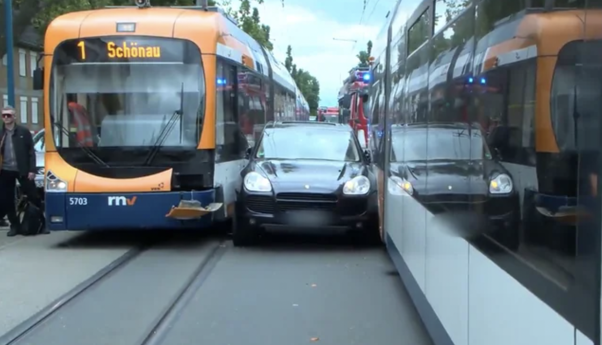 Porsche driver attempted to pass a tram, geot stuck between two of them.