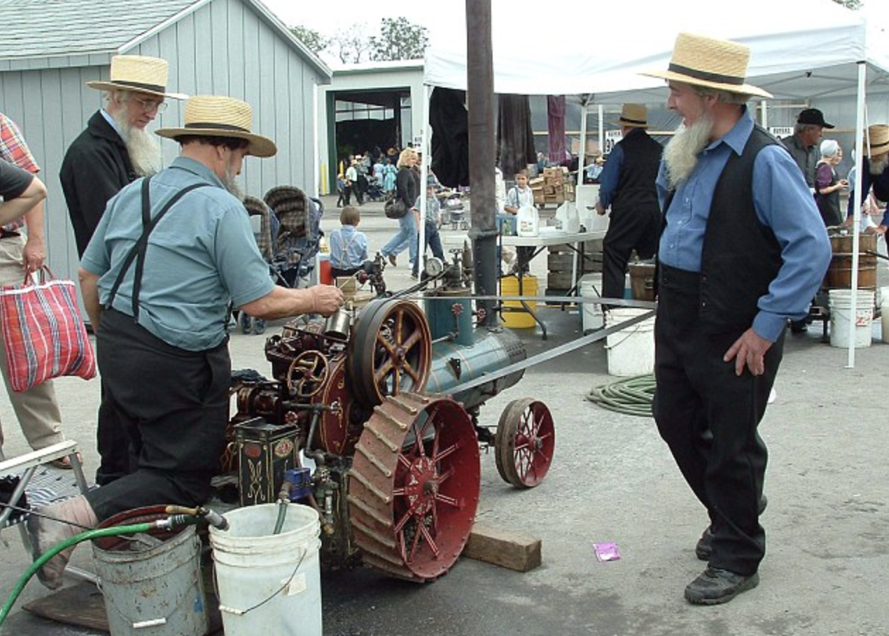 Mini steam engine powering a 10 gallon ice cream freezer at an Amish auction.