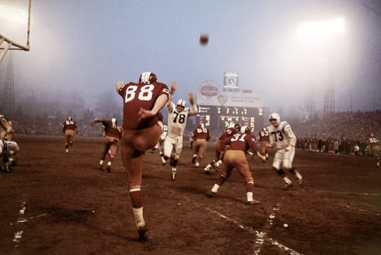Redskins punter Pat Richter punts from his own endzone.