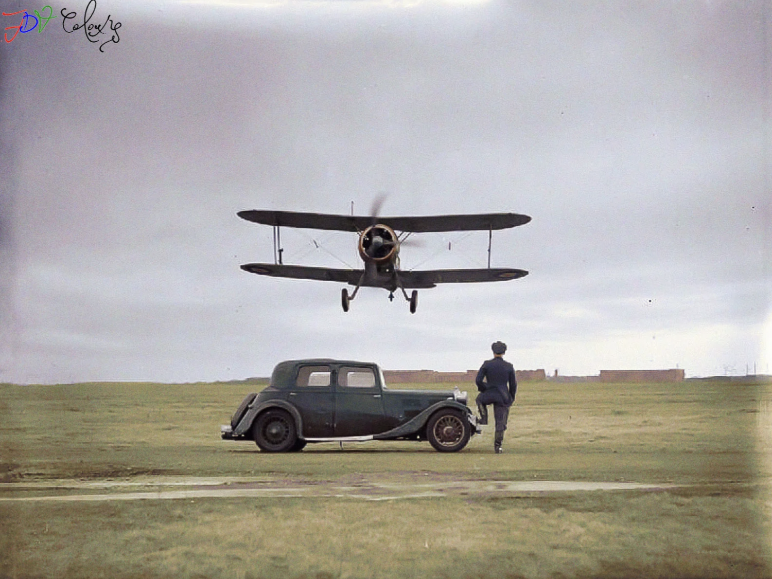 A Gloster Gladiator takes off over a Triumph Gloria, colorized, during the second world war.