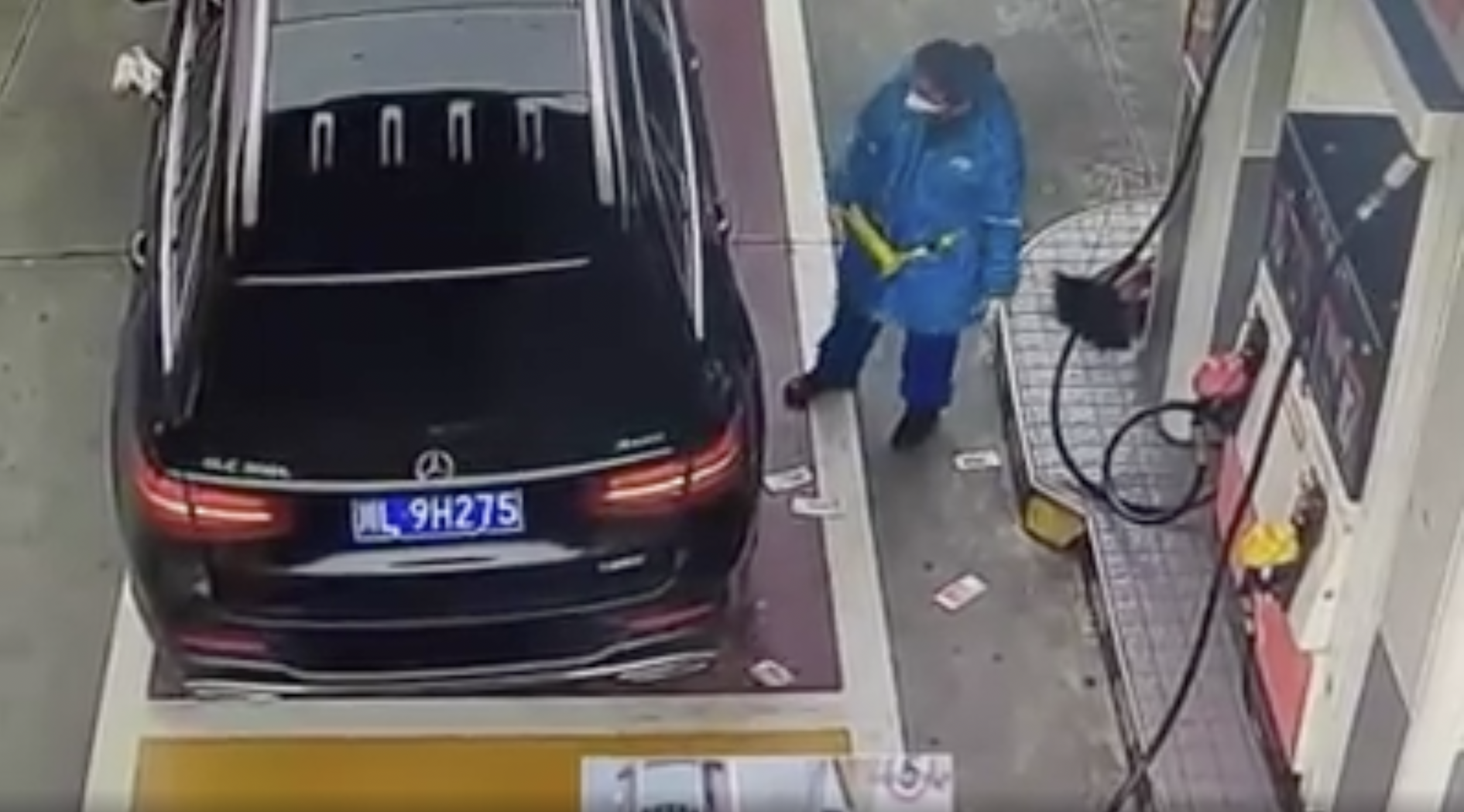 People in Mercedes throw money on the ground for gas attendant to pick up.
