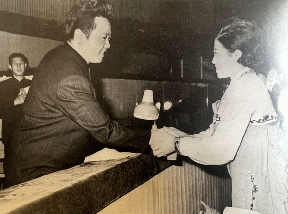 1970s photo of Kim Jong Il shaking hands with his future wife and singer Ko Yong Hui. She would become the mother of Kim Jong Un.