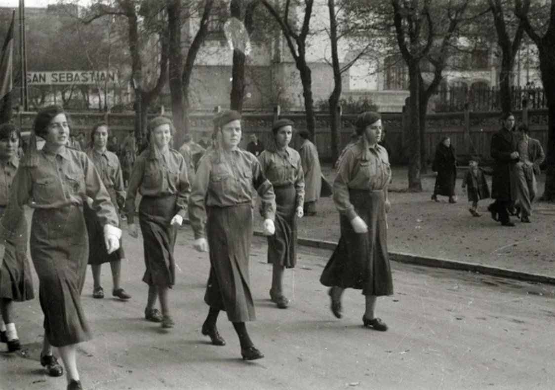 "Margaritas," the Carlist women's organization, are preparing for a military parade on the Avenue of Freedom. San Sebastián, Spain, 1936.