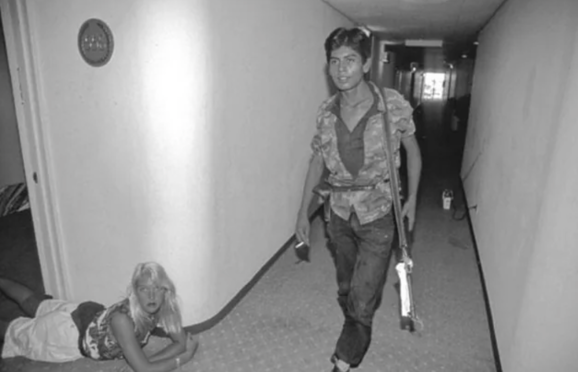 FMLN Guerilla raiding the Sheraton Hotel in San Salvador with a "surprised guest." November 1989.