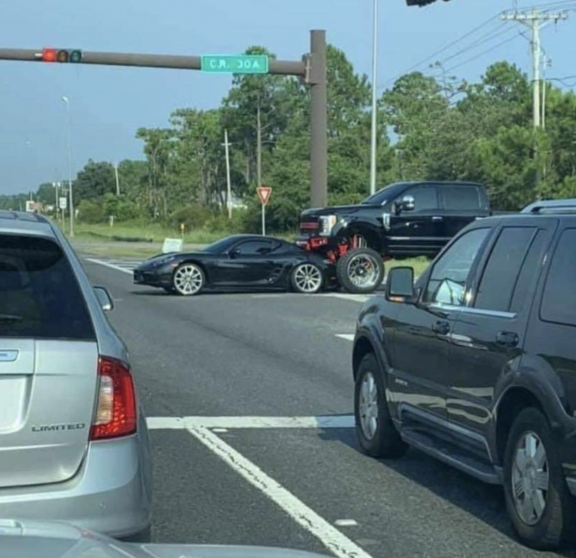 Truck lifted too high to see the Porsche in front of him.