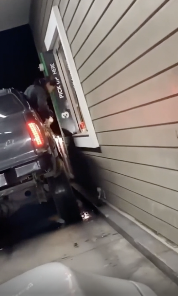 Using a lifted truck to get takeout. Driver moves too soon, and the passenger hits his head.
