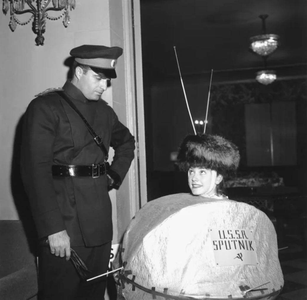A couple attends a Halloween party dressed as Sputnik and a soviet officer, 1957.