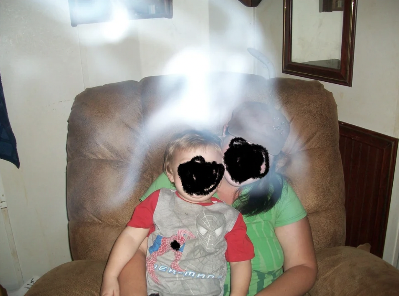 Photo of my cousin and her son taken after her brother's funeral. They all believe this was his ghost.