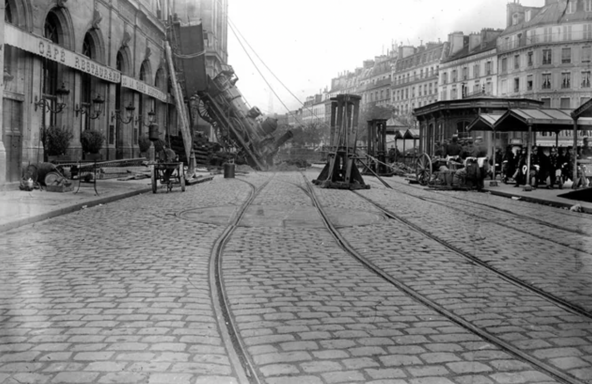   Accident at the Montparnasse station on October 22,1895. An express train derails after overrunning the buffer stop, crossing 30 meters of concourse before crashing through a wall and falling to the road below. All passengers survived, but a woman in the street was killed by falling stones. 