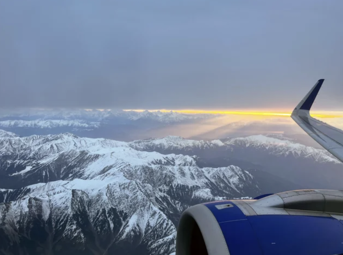 Sunrise view of the Himalayas from an airplane.