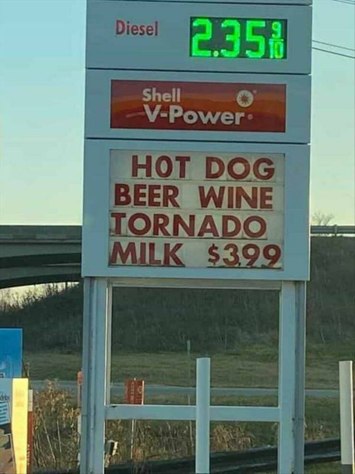 street sign - Diesel 2.35% Shell VPower Hot Dog Beer Wine Tornado Milk $399