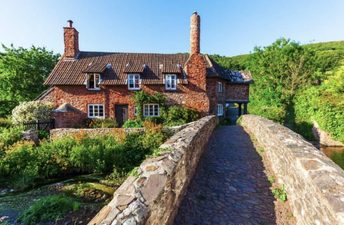 House besides a bridge and river in Southwest England.