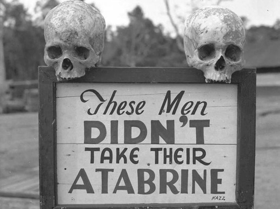 An advertisement sign for the drug Atabrine, an anti-malaria drug, In Papua New Guinea, 1942.