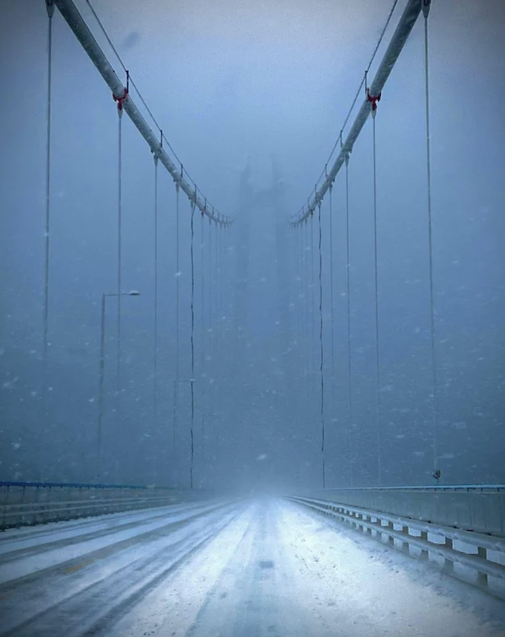 The Hardanger Bridge located in Norway during a really snowy day.