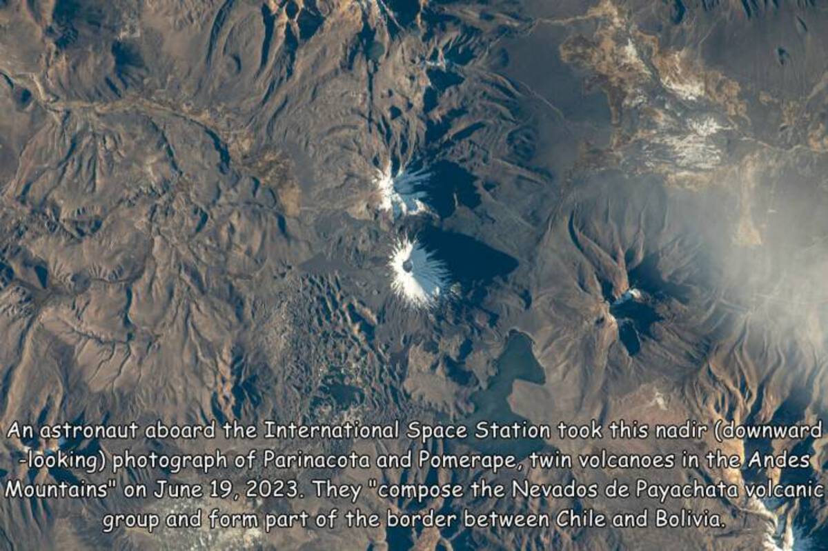 earth - An astronaut aboard the International Space Station took this nadir downward looking photograph of Parinacota and Pomerape, twin volcanoes in the Andes Mountains" on . They "compose the Nevados de Payachata volcanic group and form part of the bord