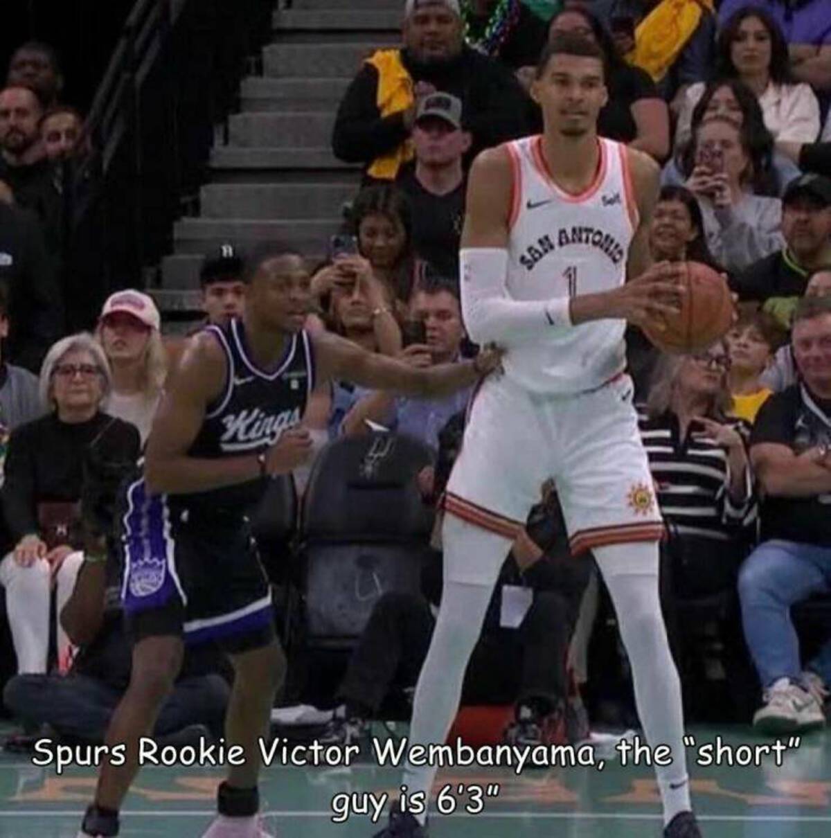 basketball player - T Kings San Antonio Spurs Rookie Victor Wembanyama, the "short" guy is 6'3"