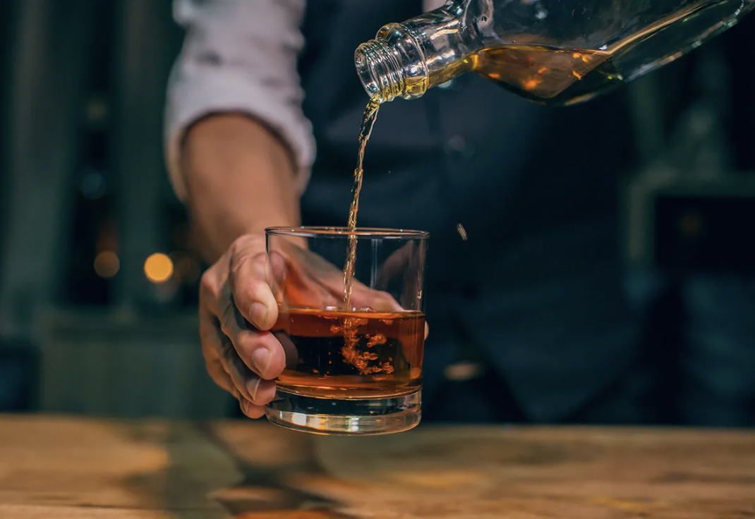 man pouring whiskey - M