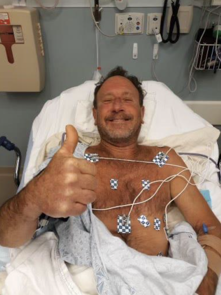 Cape Cod lobster diver giving a thumbs up in his hospital bed after being swallowed and spit out of a humpback whale.
