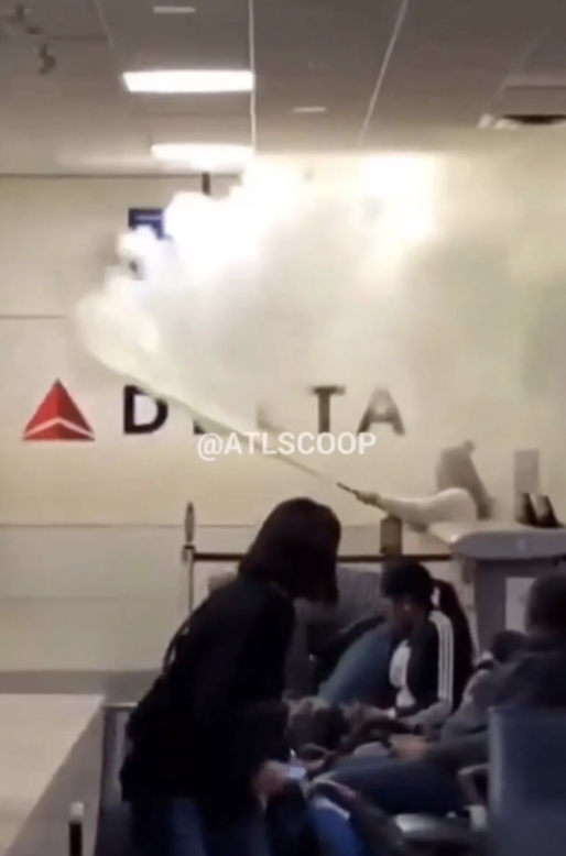 woman at atlanta airport with fire extinguisher