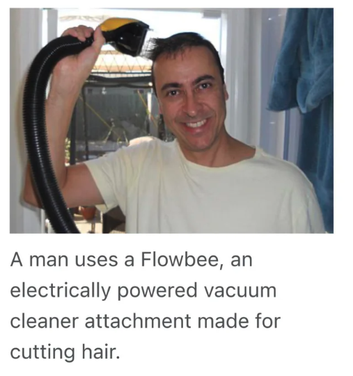 shoulder - A man uses a Flowbee, an electrically powered vacuum cleaner attachment made for cutting hair.