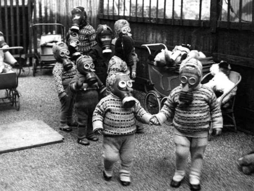 School children wearing gas masks in 1939 England during World War II.