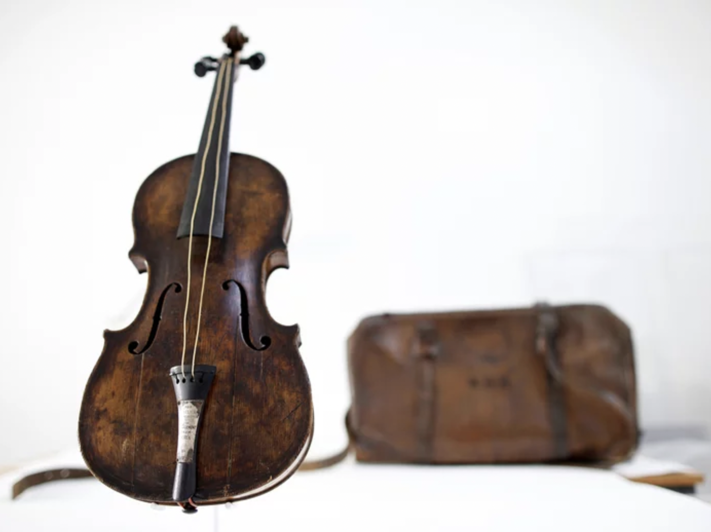 This looks like a stock photo of a violin. The instrument in that picture is the Hartley Violin. It was owned by Wallace Hartley, the bandmaster and lead violinist on the Titanic. It was the one he carried with him on the night the ship sank. Survivors reported seeing Hartley and his band on the deck of the ship during the sinking, playing to calm passengers as they boarded the insufficient lifeboats. This is the exact instrument he played. We have his violin because at some unknown point before his death, Hartley tucked the violin back into its monogrammed case for safekeeping.