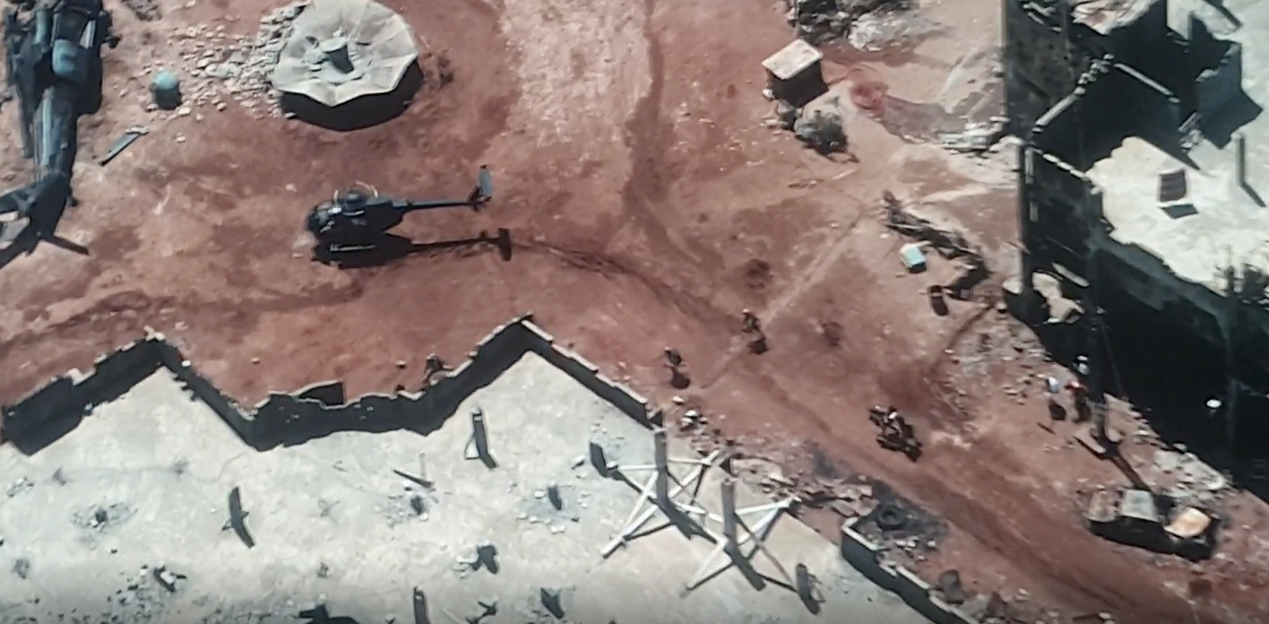 In “Black Hawk Down,” 2001, camera men with a boom can clearly be seen running behind and below the soldiers with a boom when they cut to this wide angle. 