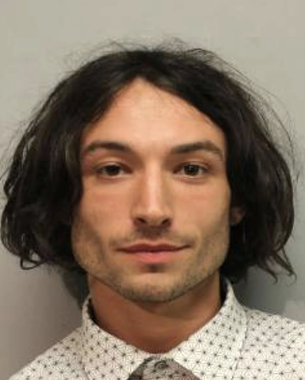 Take your pic of recent Ezra Miller mugshots. This one in March of 2022 was for disorderly conduct and harassment.
