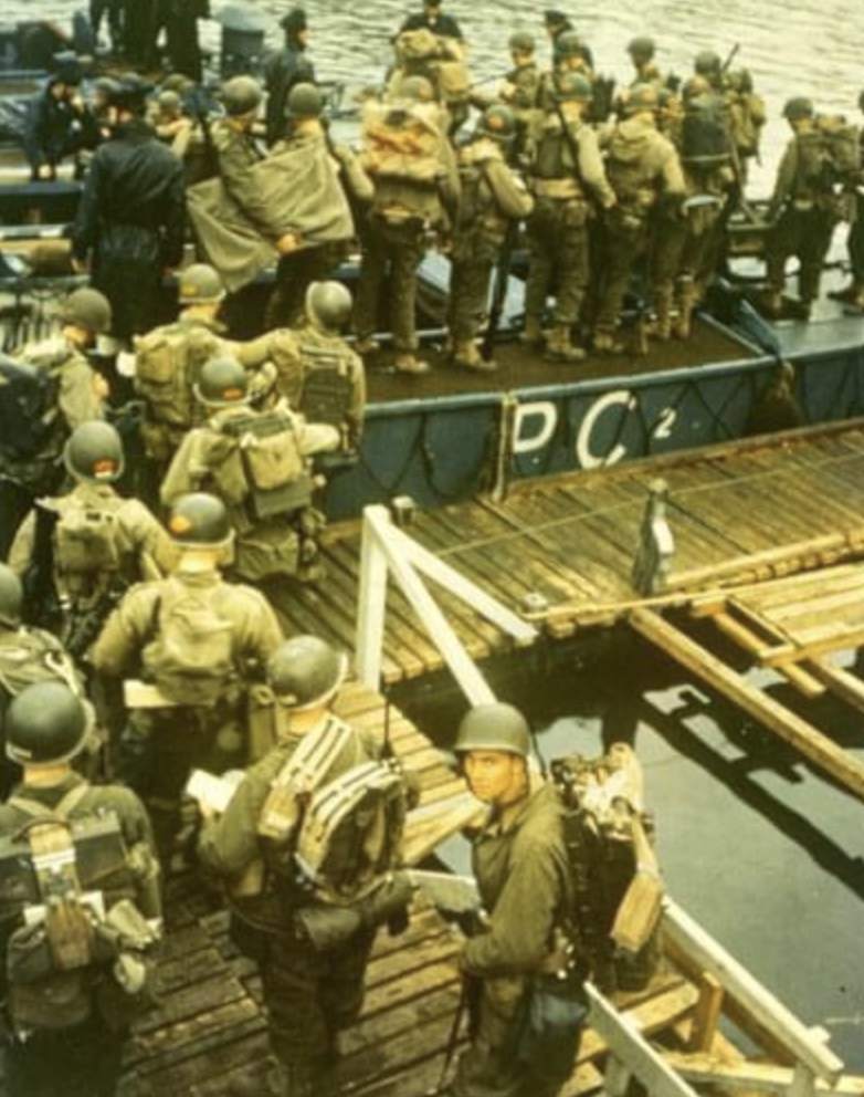Apprehensive GIs load onto a British landing craft for the invasion of Normandy.