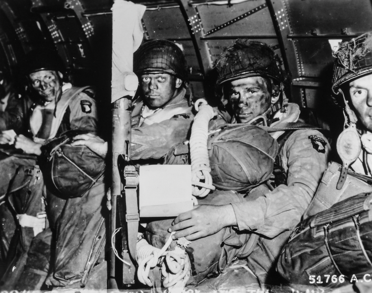 Paratroopers just before they took off for the initial assault of D-Day. Eisenhower's D-Day order in hands of paratrooper in foreground.