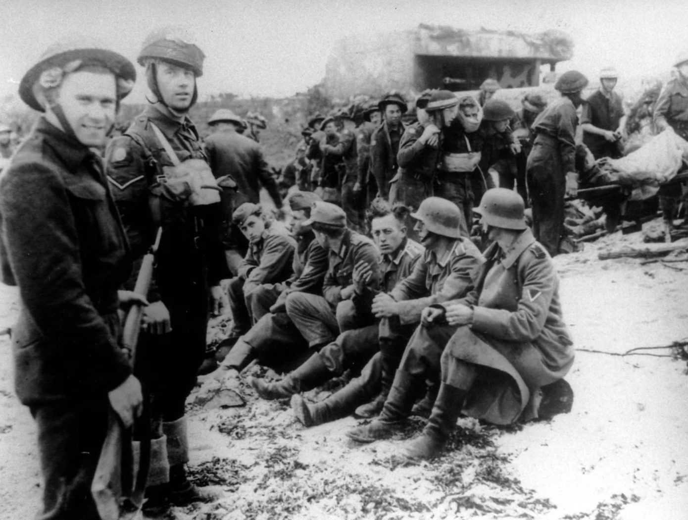 British and Canadian troops guard German prisoners.