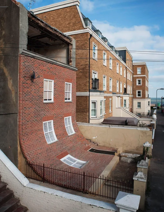 A real house in Margate (UK) purposefully built with a sliding facade by artist Alex Chinneck in 2014