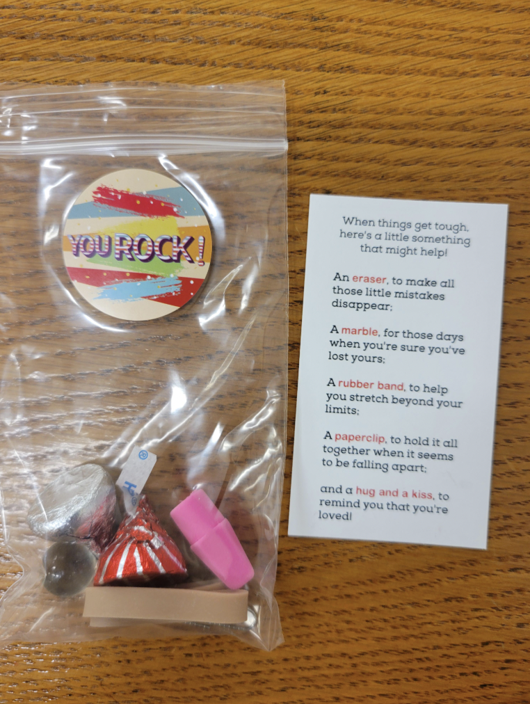 badge - You Rock! When things get tough here's a little something that might help An eraser, to make all those little mistakes disappear A marble, for those days when you're sure you've lost yours A rubber band to help you stretch beyond your A paperclip,