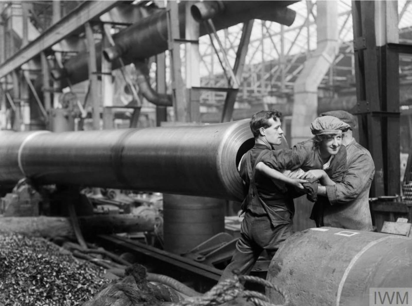 Munitions worker being used to clean the barrel of a 15-inch naval gun during WW1.