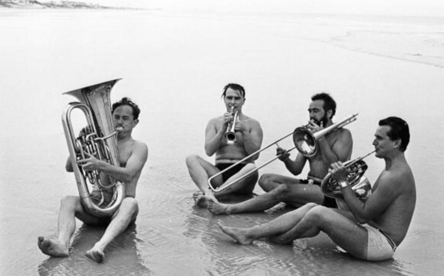 Musicians from the London Symphony Orchestra playing their instruments on Daytona Beach, Florida, 1967.