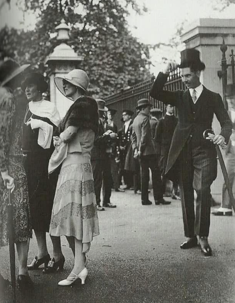 Guy tips his hat to a group of ladies, 1920s.