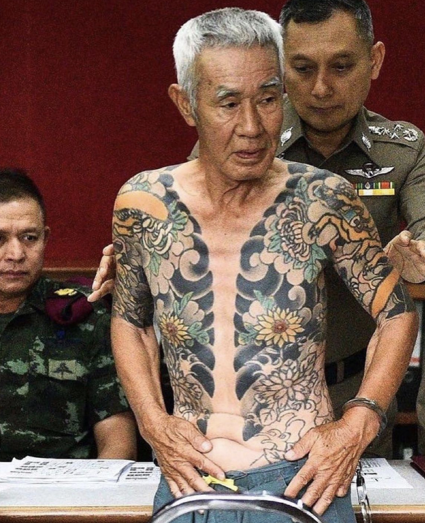 Yakuza boss being arrested in Thailand after photos of his tattoos went viral online, 2018.