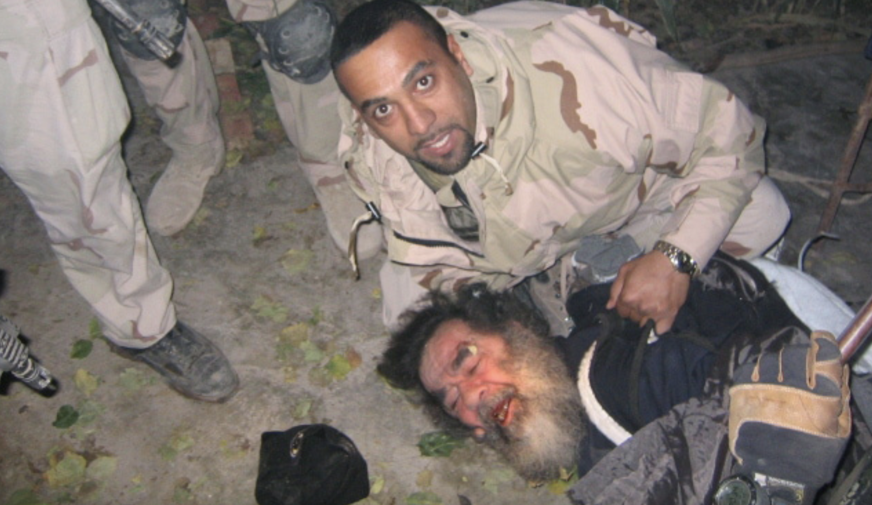 Saddam Hussein is dragged from his hiding hole, December 13, 2003.