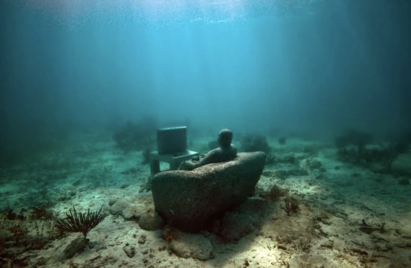 Statue of a guy watching TV Underwater. It will become a coral reef. 