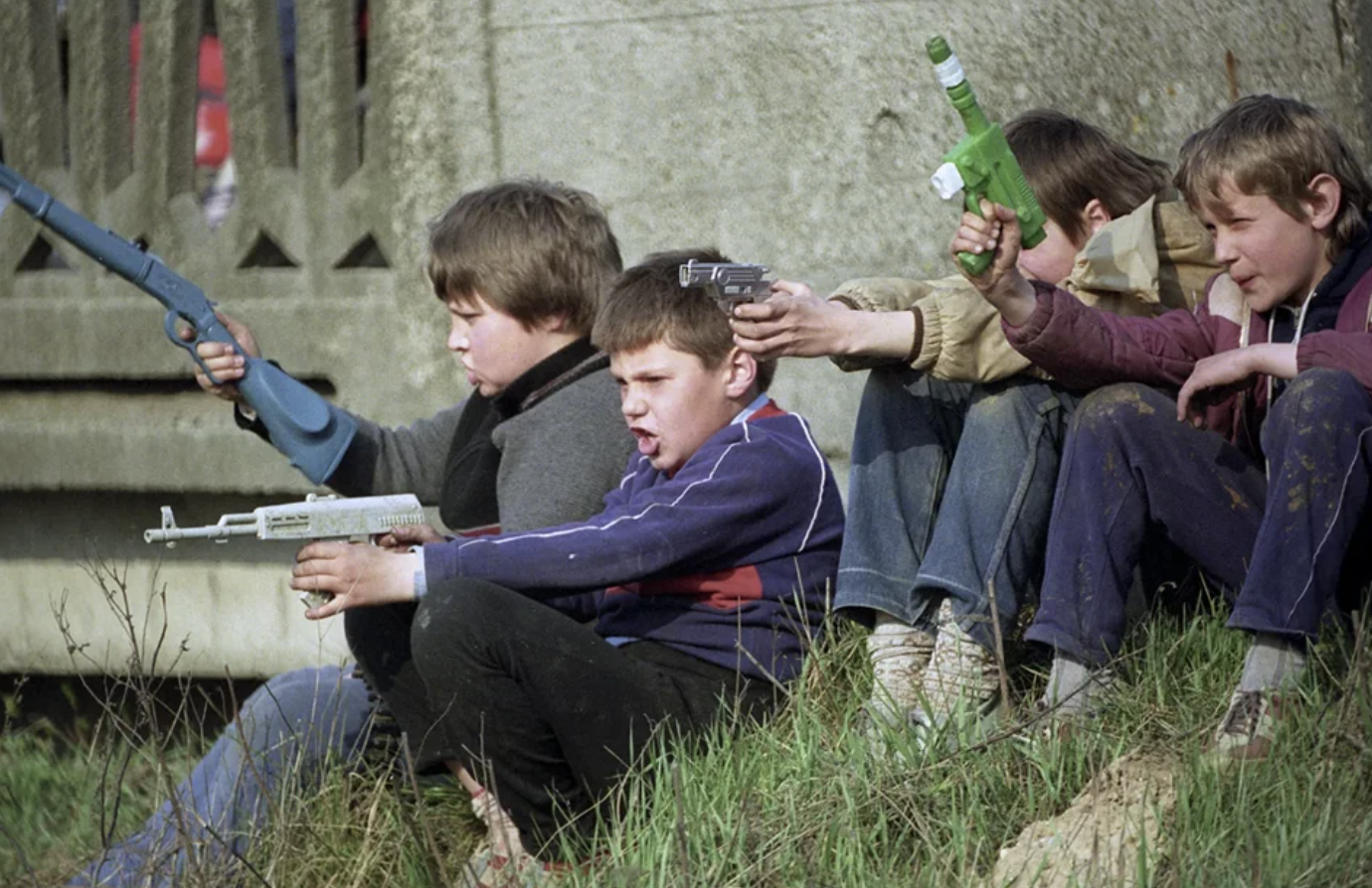 Children play soldiers while watching exercises of the Armed Forces of the Soviet Union. 1990.